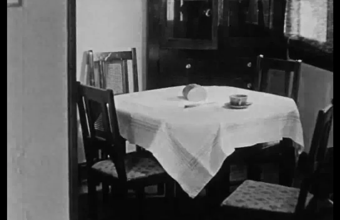 a dining room table with a white table cloth