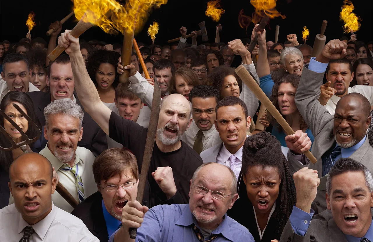 a large group of people with torches in their hands