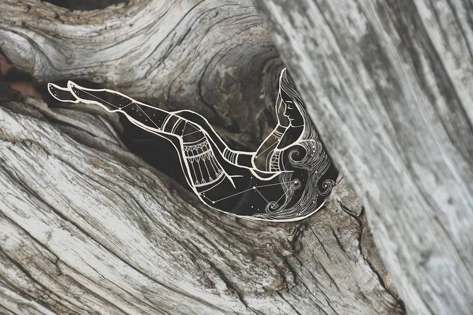 a close up of a piece of wood with a bird on it