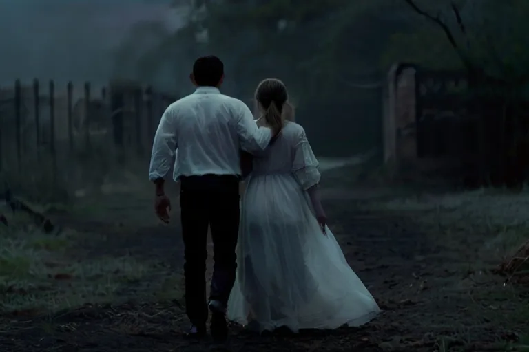 a man and a woman walking down a dirt road