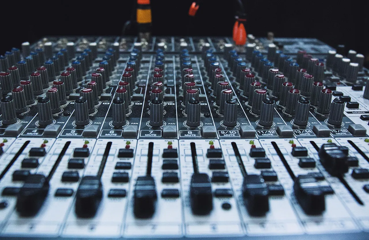 a sound board with many knobs and a microphone