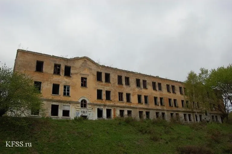 an old abandoned building sitting on top of a hill