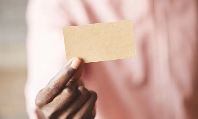 a person holding a piece of paper in their hand