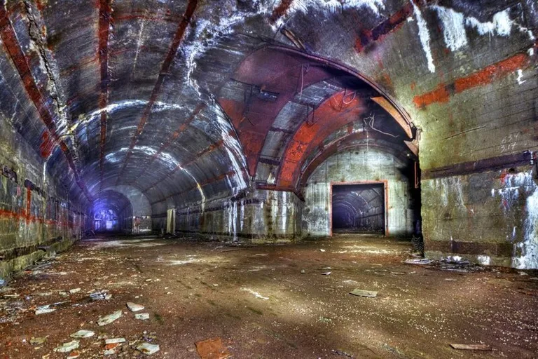 an abandoned tunnel with graffiti on the walls