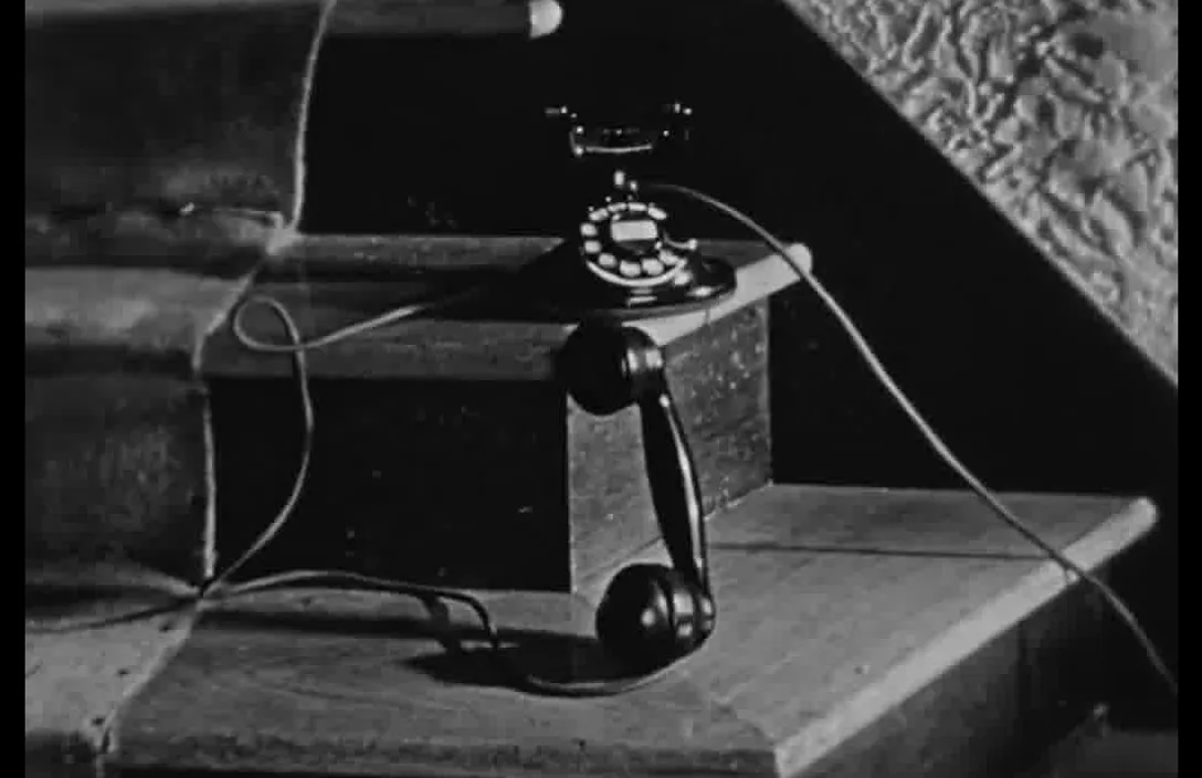 an old fashioned telephone sitting on top of a wooden box