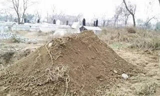 a pile of dirt sitting in the middle of a field