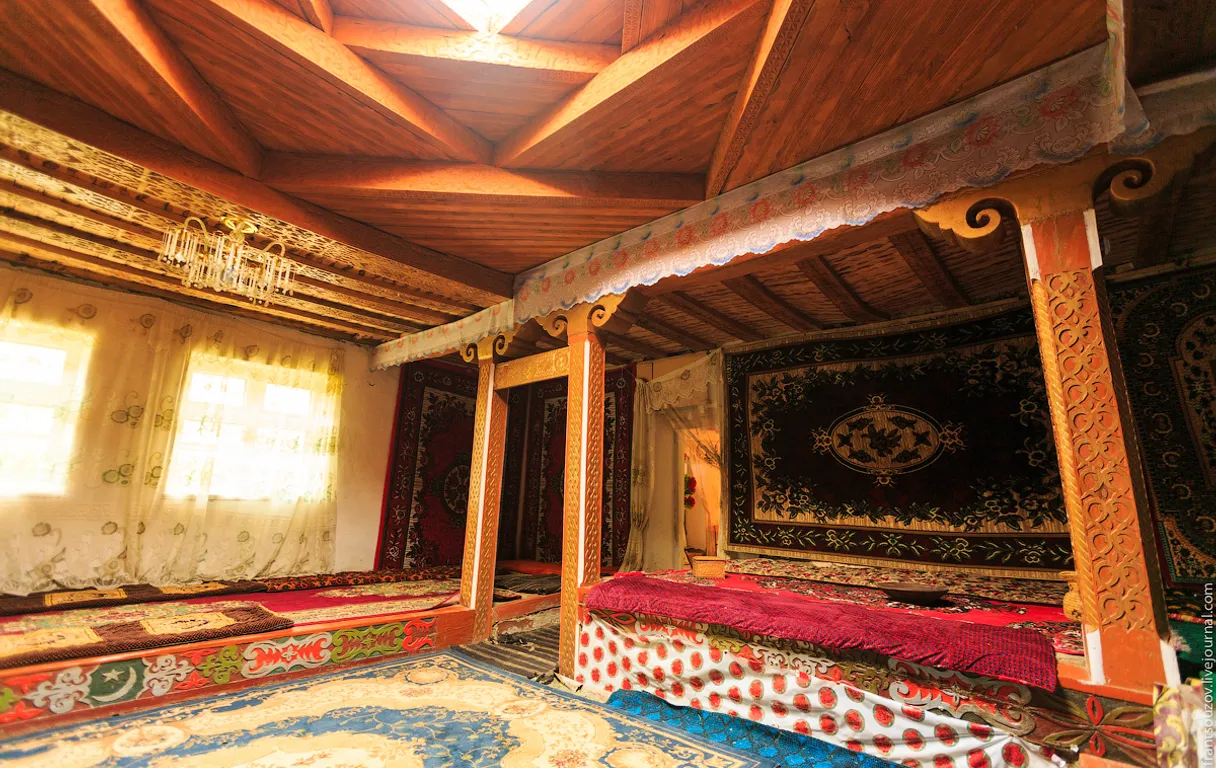 a room with a bed and rugs in it