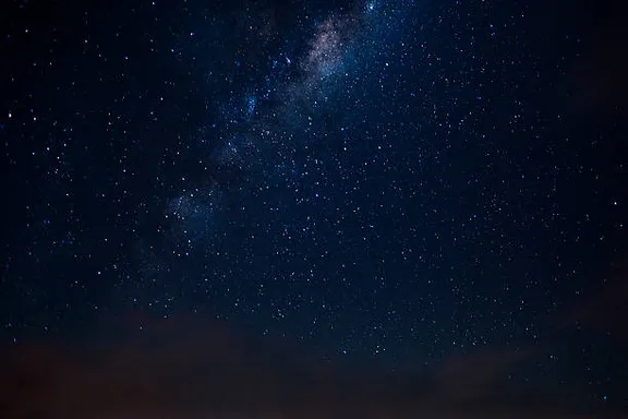 a view of the night sky with the milky in the background