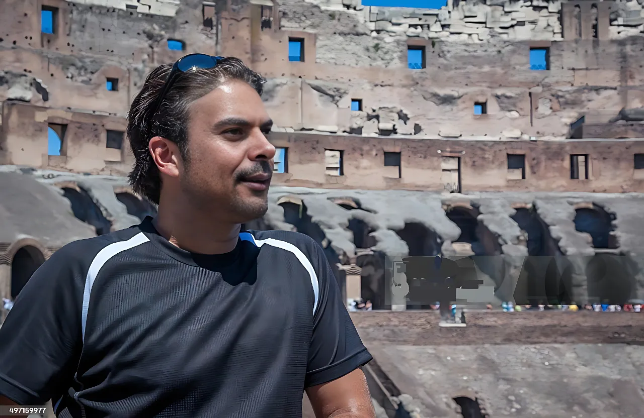 a man standing in front of an old building