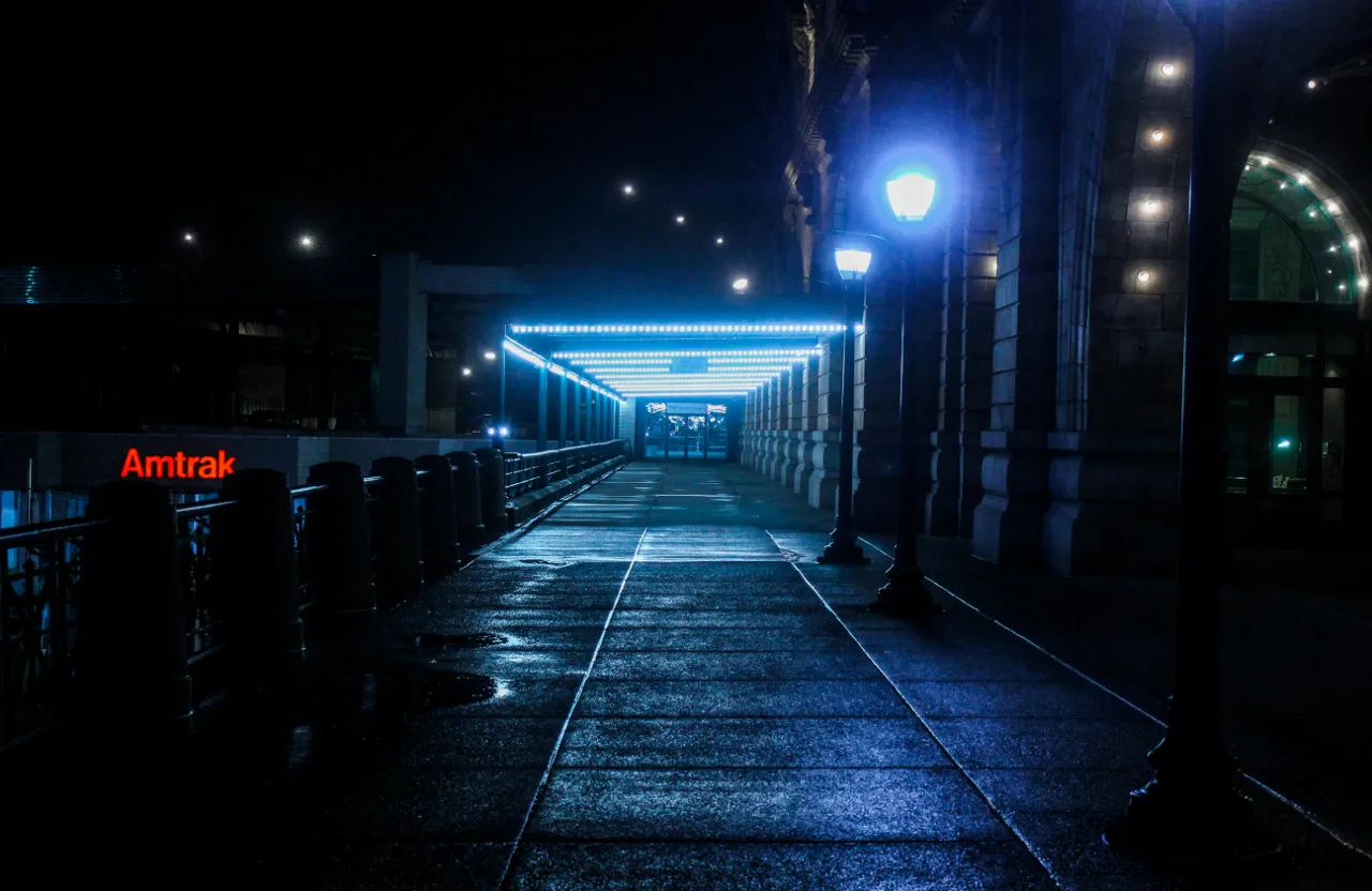 a street at night with a street light on the side of the road