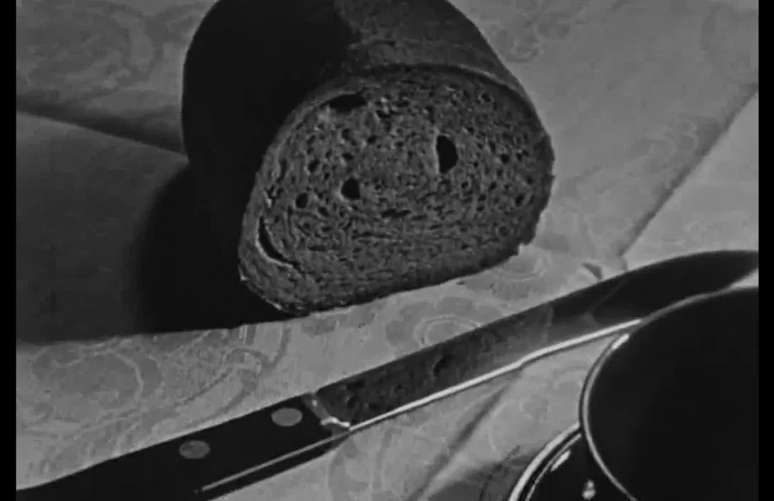 a loaf of bread sitting on top of a table next to a knife