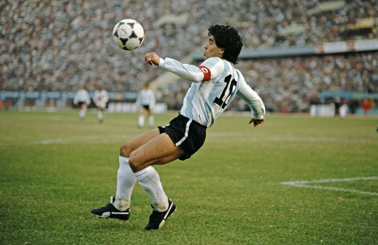 diego armando maradona kicking a soccer ball on top of a field