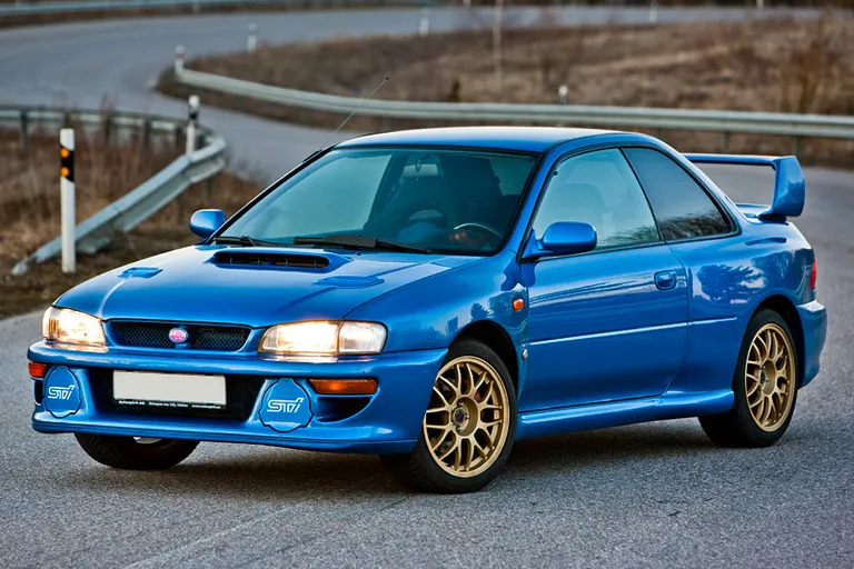 a blue car beating a rally race on gravel