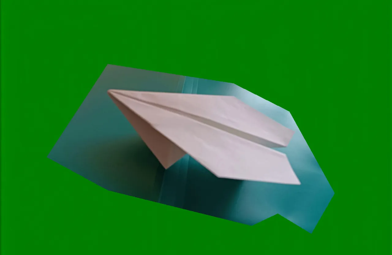 an origami paper airplane on a green background