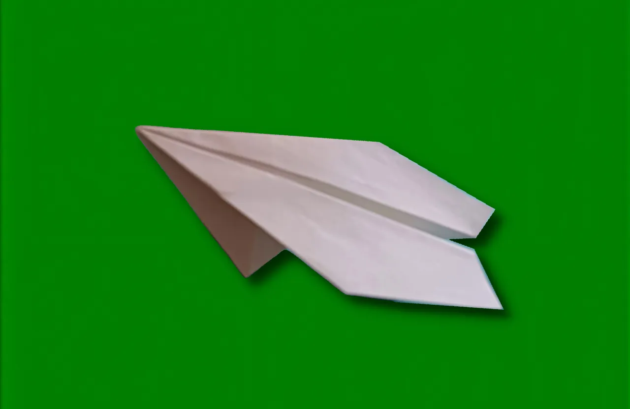 Flying a white paper airplane on a green background