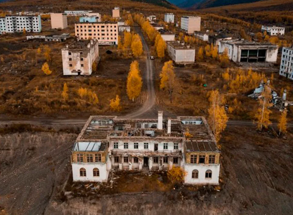 an aerial view of a building in the middle of a field