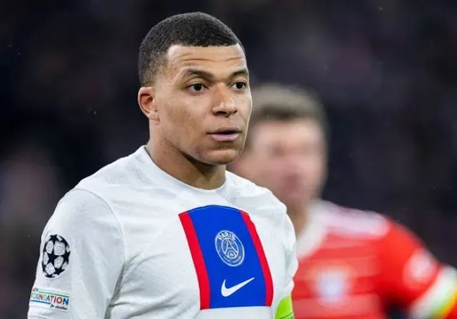 a close up of a mbappe wearing a white shirt