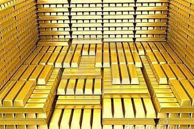 a large amount of gold bars stacked in a bin