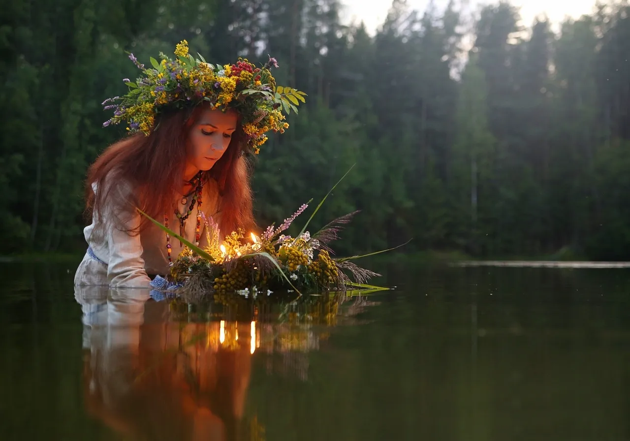 a woman with a wreath on her head sitting in the water