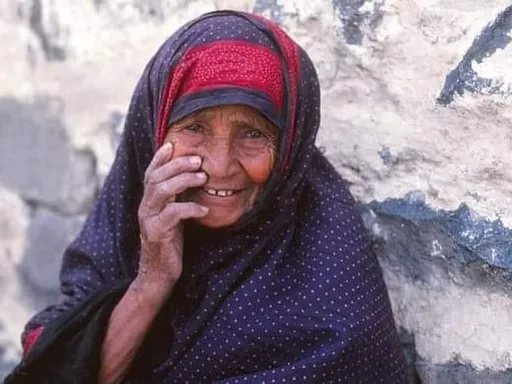 a woman in a headscarf talking on a cell phone