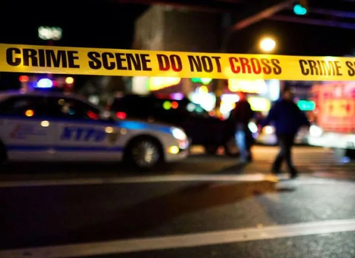 a police car parked in front of a police tape