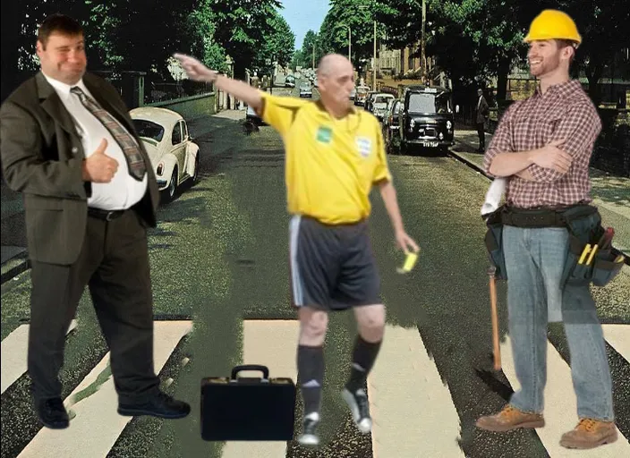 two men standing on a crosswalk with a suitcase