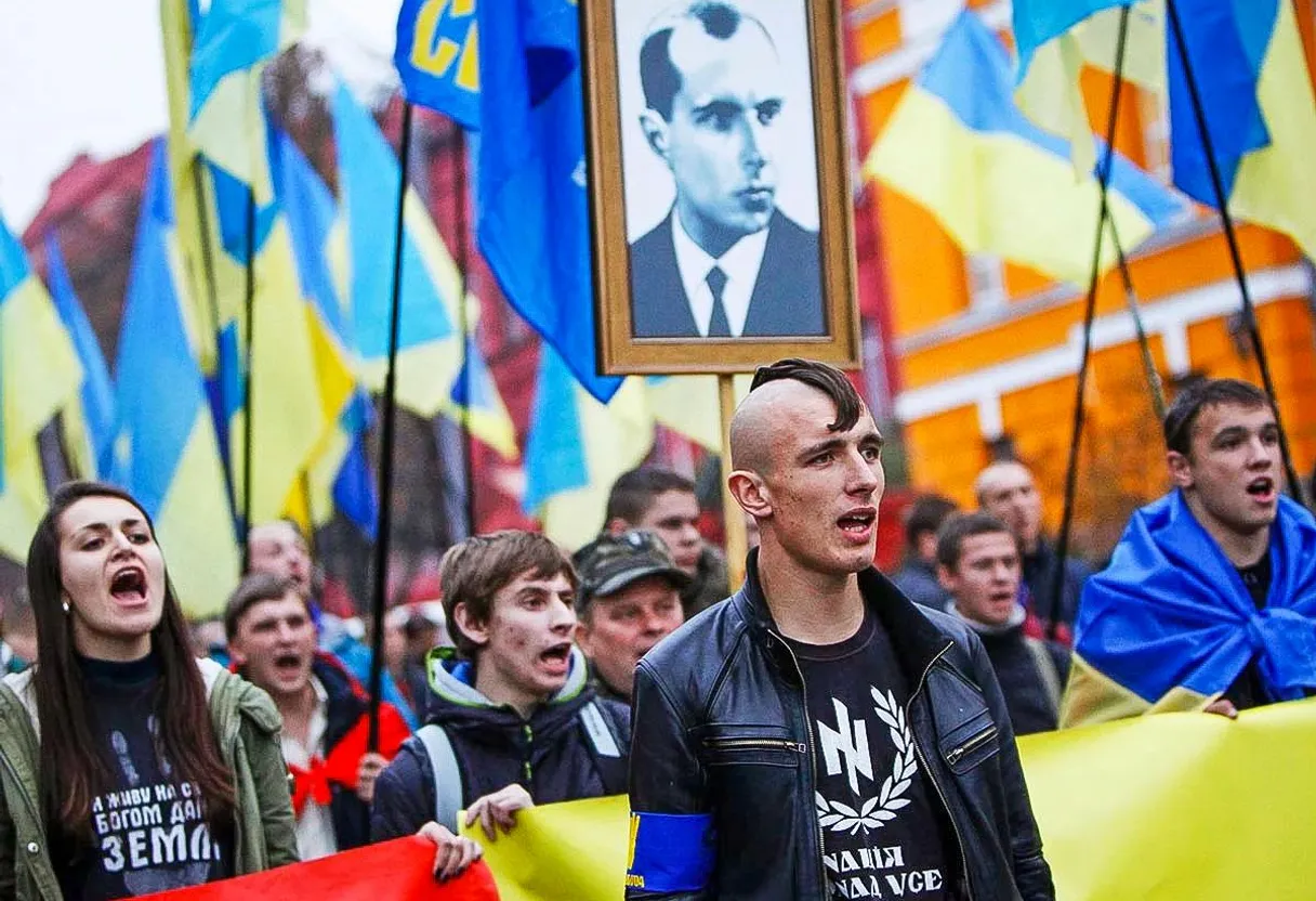 a group of people holding flags and a picture of a man