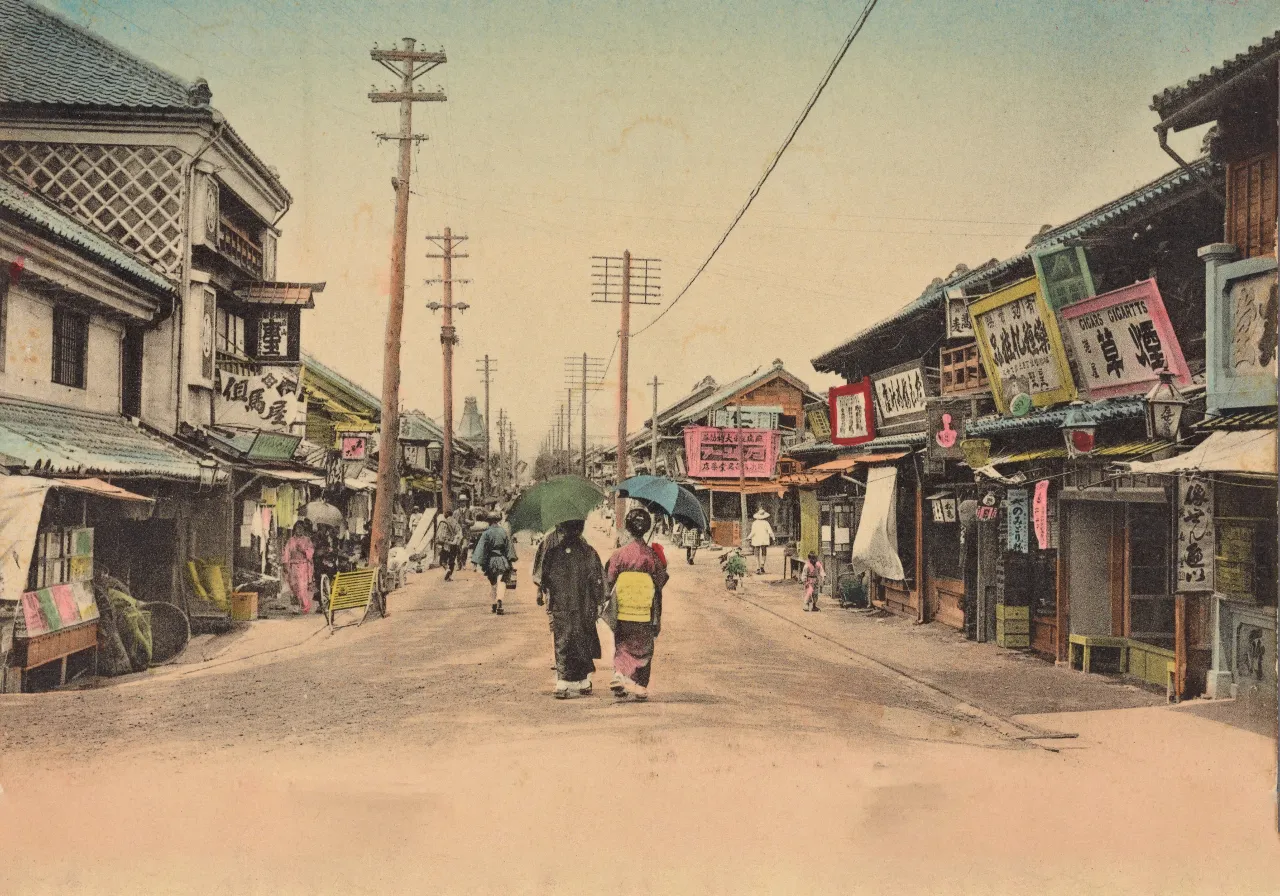 a group of japane people walking down a street holding umbrellas