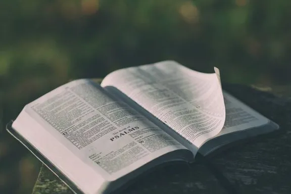 an open book sitting on top of a wooden table