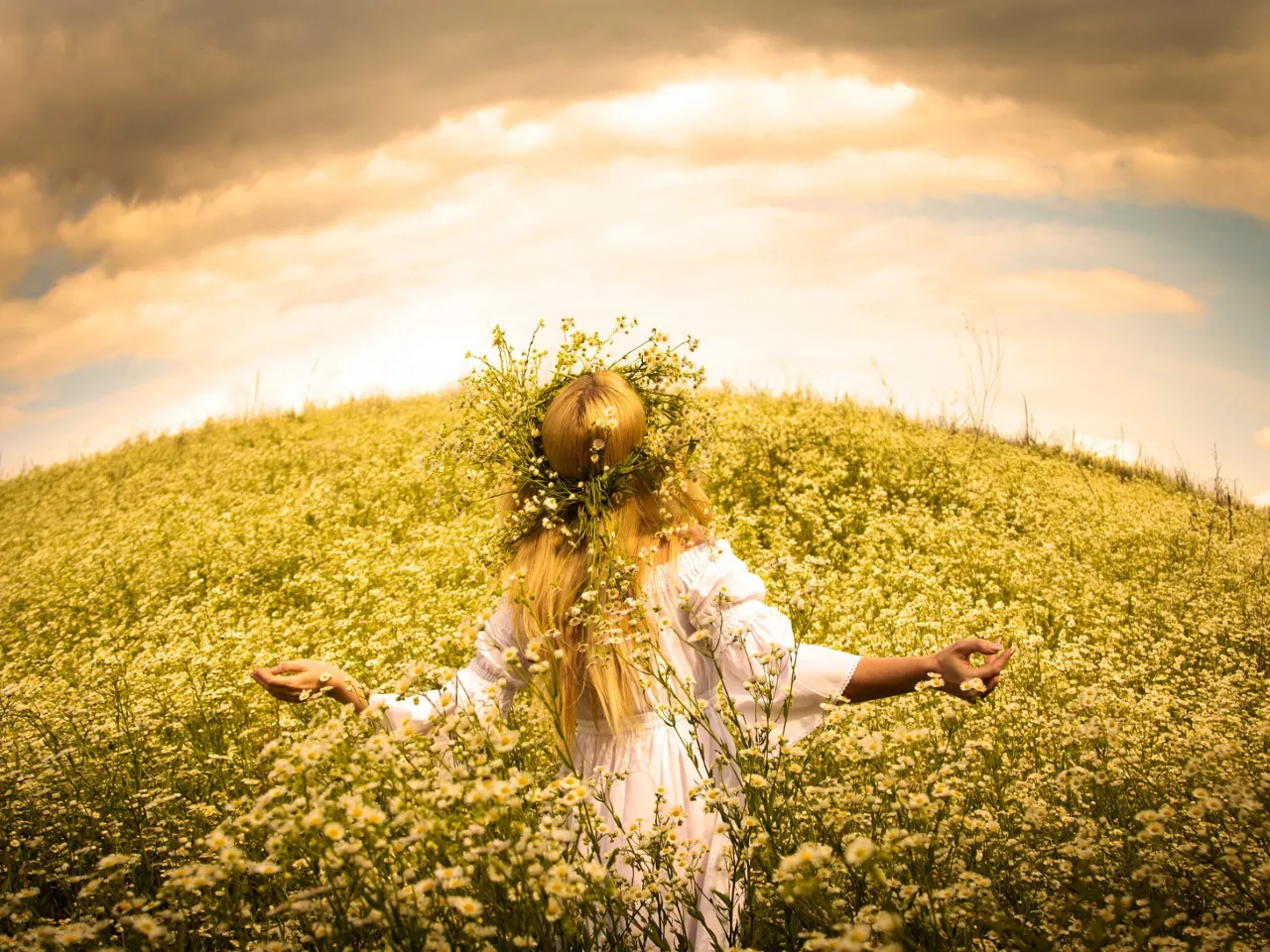 a woman standing in a field of flowers