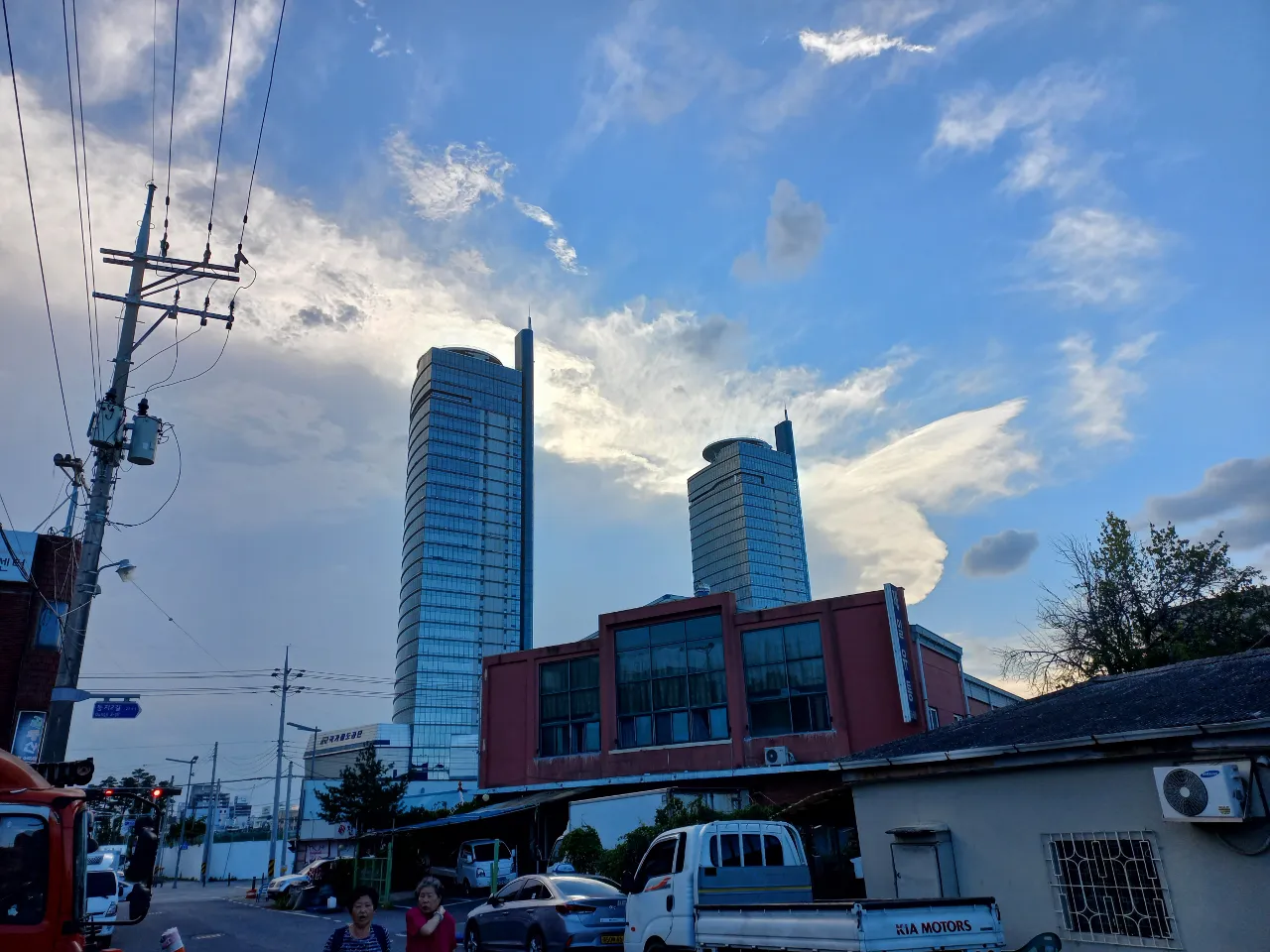 a couple of tall buildings sitting on the side of a road