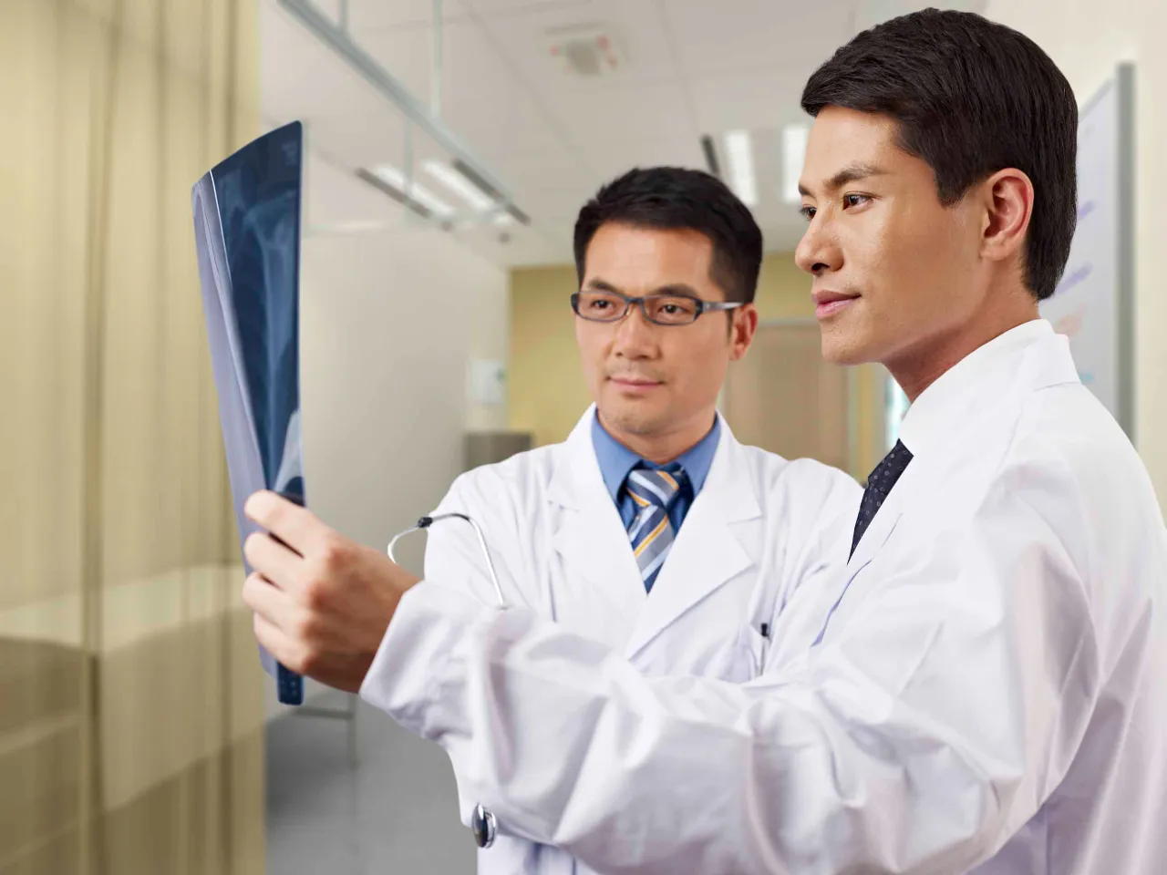 Japanese doctors hold a test tube in their hands