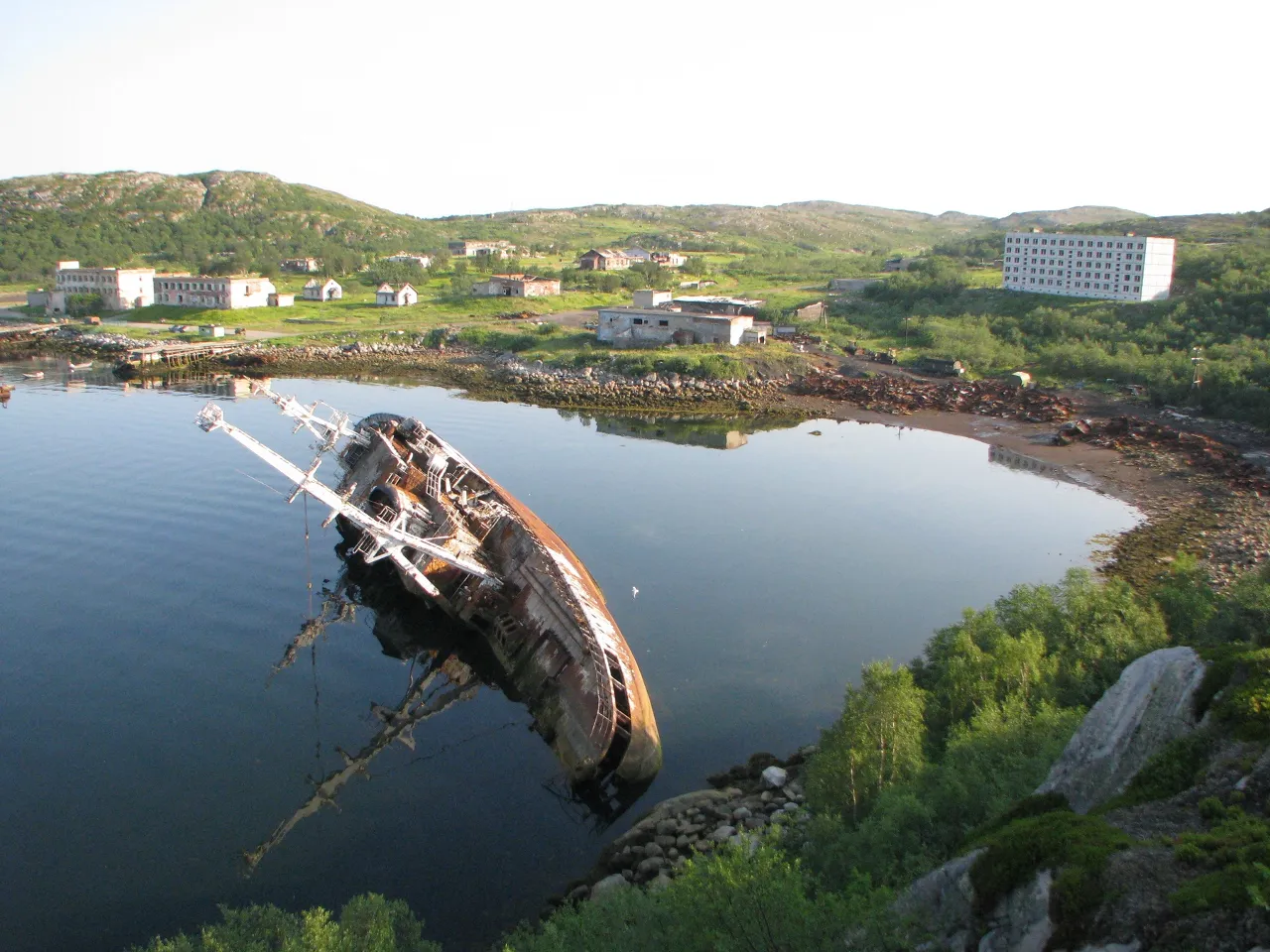 a boat sitting in the middle of a body of water