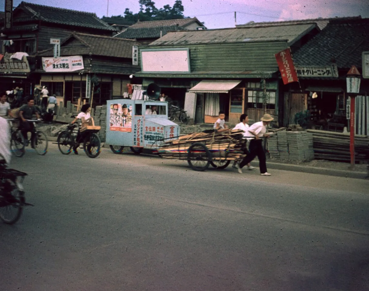 a group of people riding bikes down a street