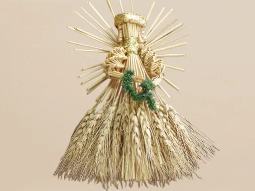 a statue made of straw with a wreath on top of it