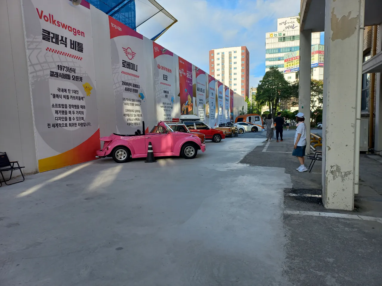 a pink car parked on the side of a road