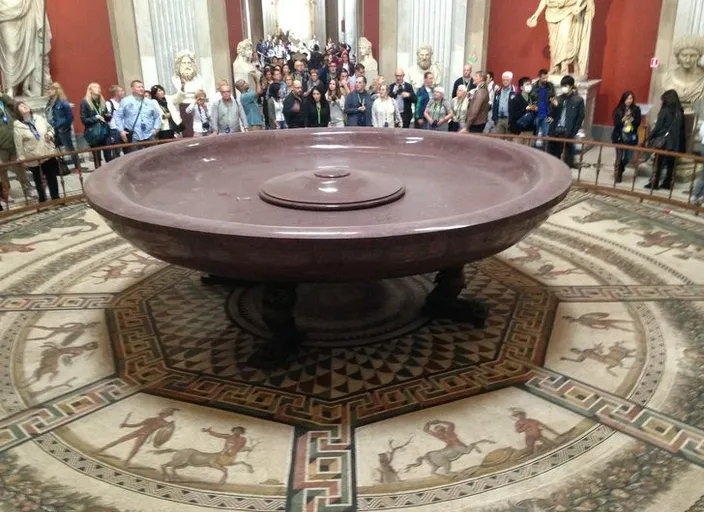 a group of people standing around a large bathtub