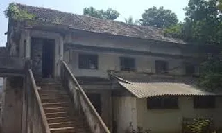 an old house with stairs leading up to it