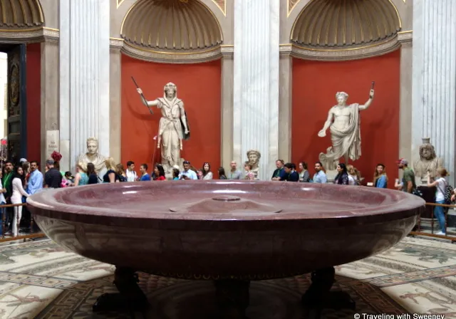 a group of people standing around a large bathtub