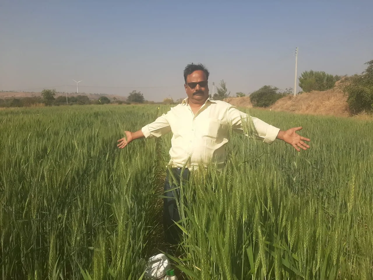 Pandu, a man standing in a field of tall grass