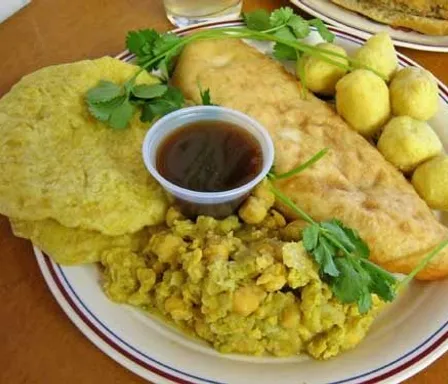 a white plate topped with food on top of a wooden table