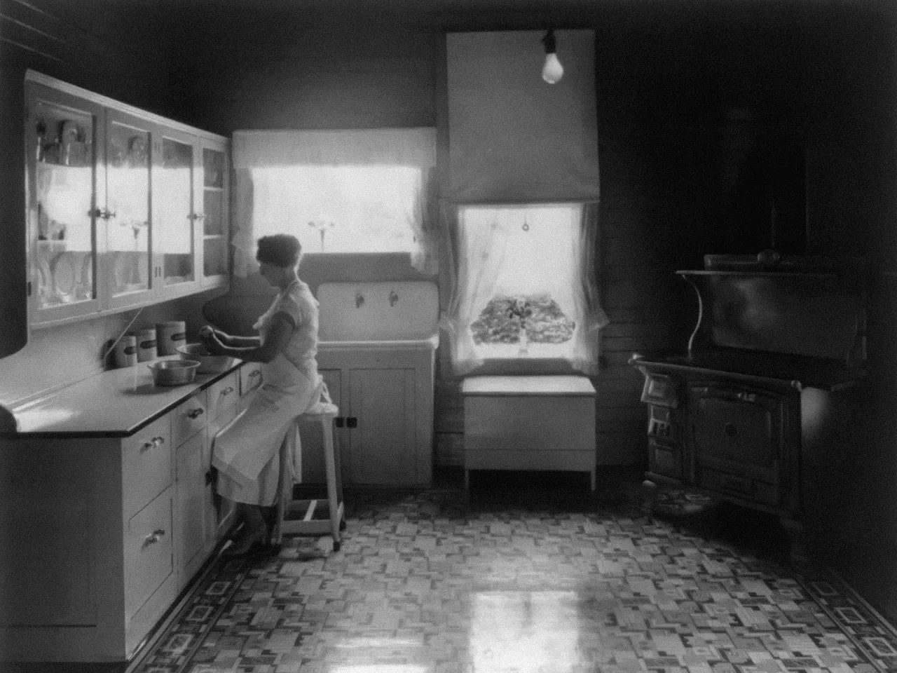 a woman standing in a kitchen preparing food