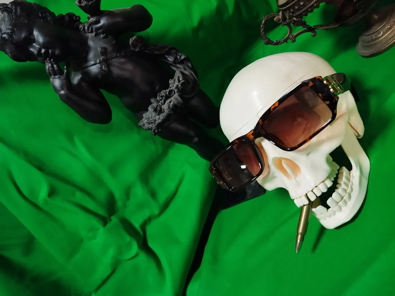 a fake skull wearing sunglasses and a white helmet