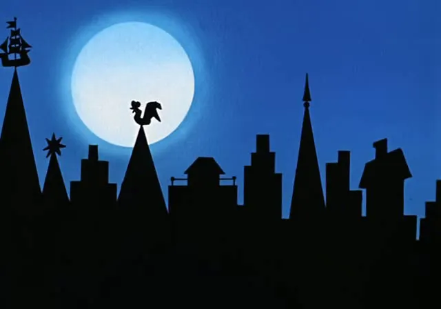 a silhouette of a city at night with a full moon