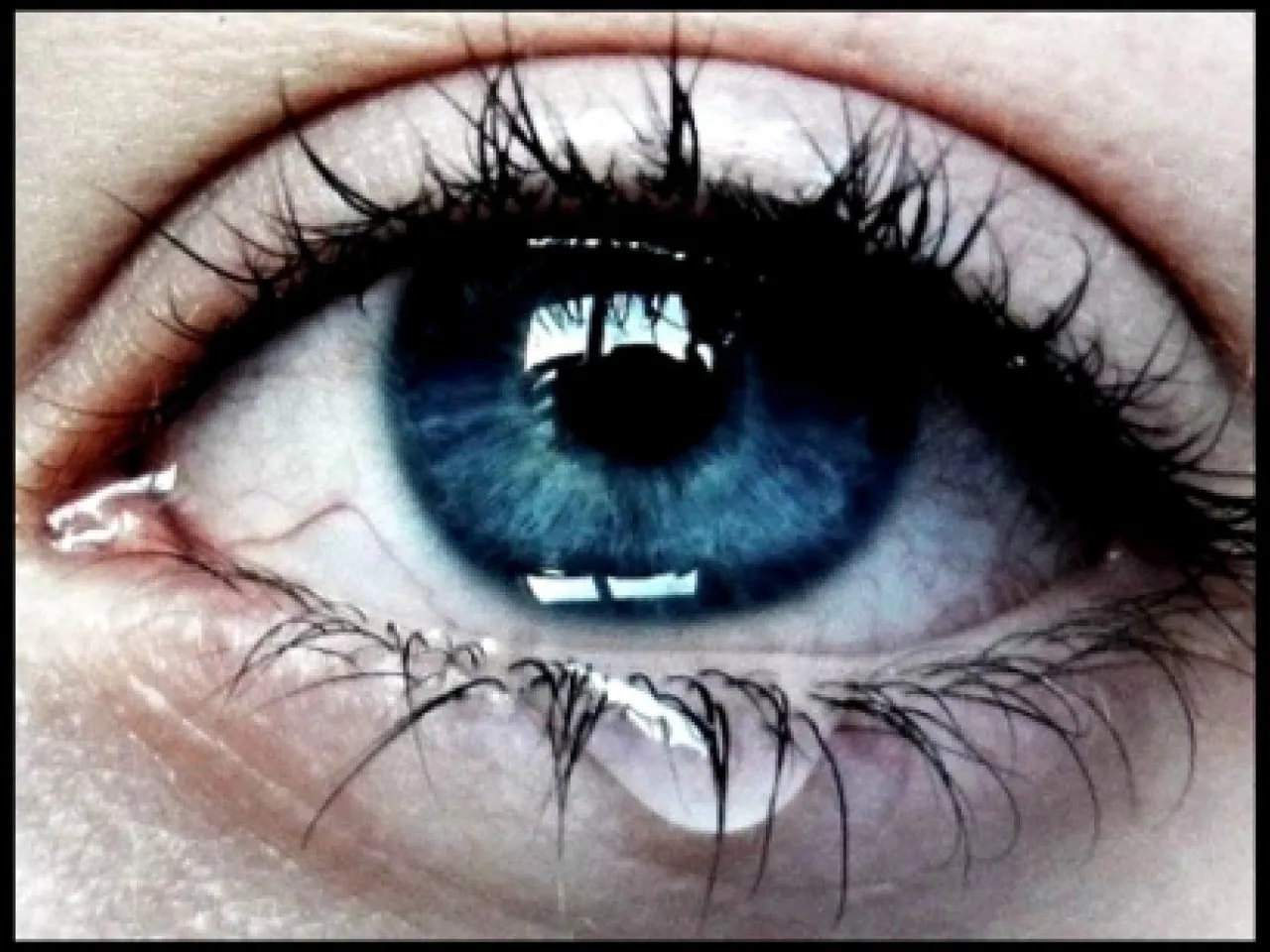 a close up of a person's blue eye