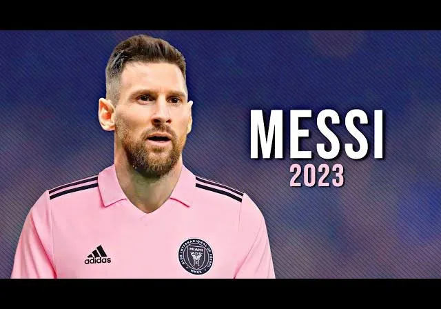 a man in a pink shirt with the words messi on it