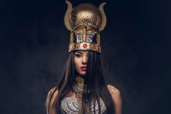 a woman wearing a helmet with horns on her head