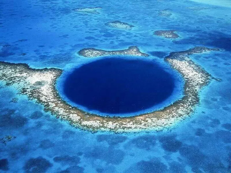 a large blue hole in the middle of the ocean