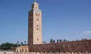 a tall clock tower towering over a city, plane crashes into the tower on fire