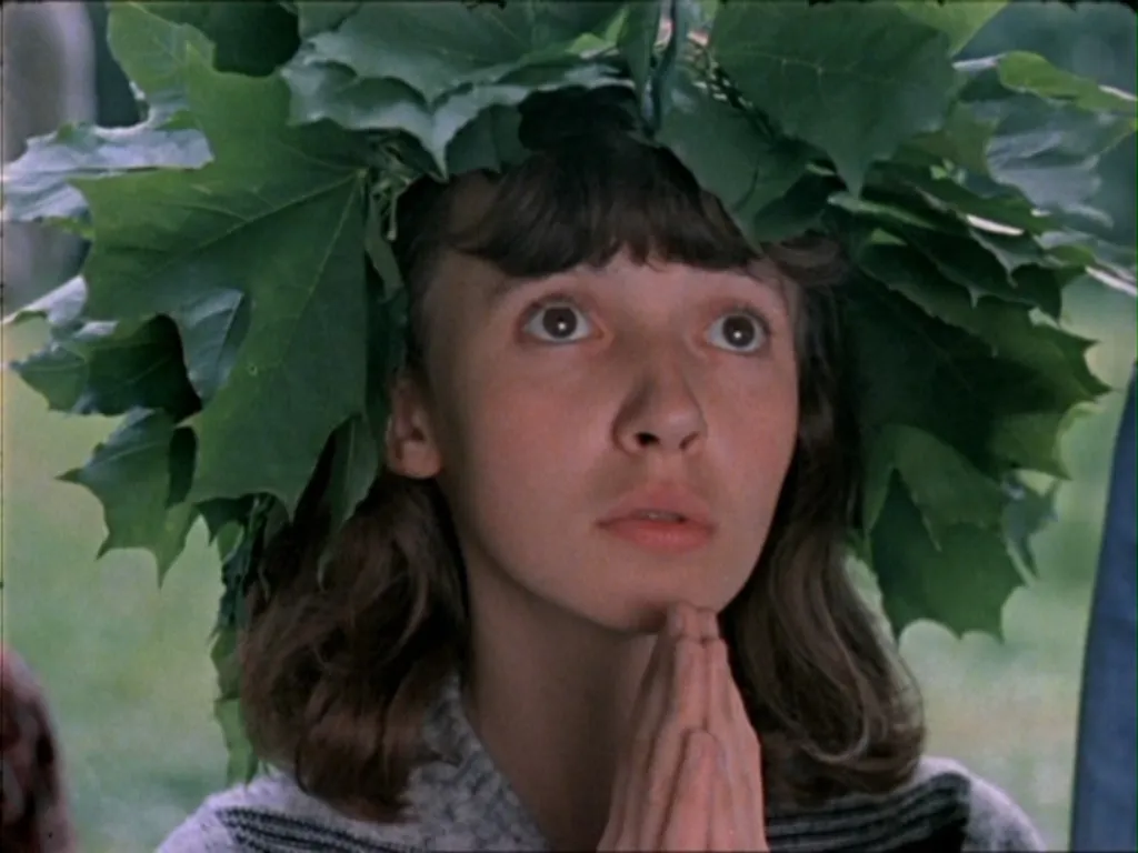 a woman with a wreath of leaves on her head